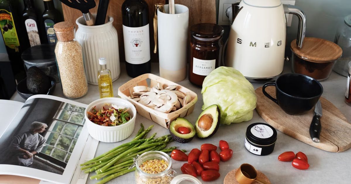 A variety of fresh ingredients and kitchen tools for preparing a healthy meal.
