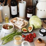 A variety of fresh ingredients and kitchen tools for preparing a healthy meal.